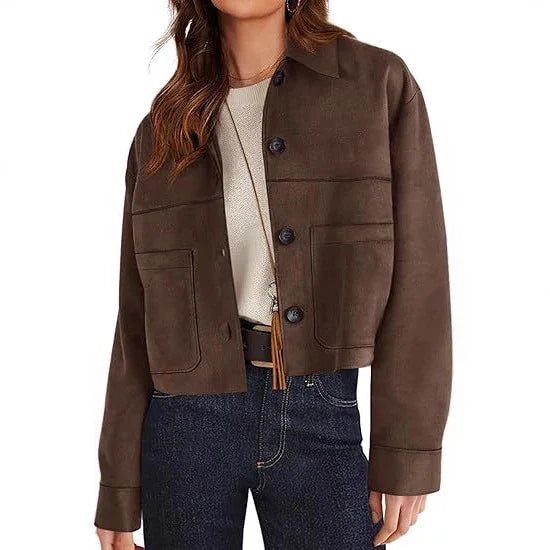 woman wearing brown cropped button-up suede jacket with front pockets and blue jeans