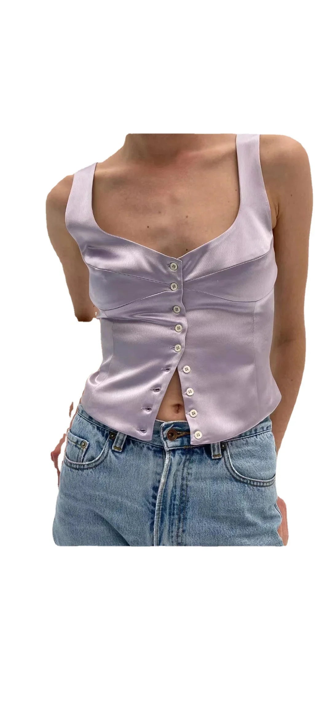 Woman wearing light purple satin buttoned crop top paired with high-waisted blue jeans