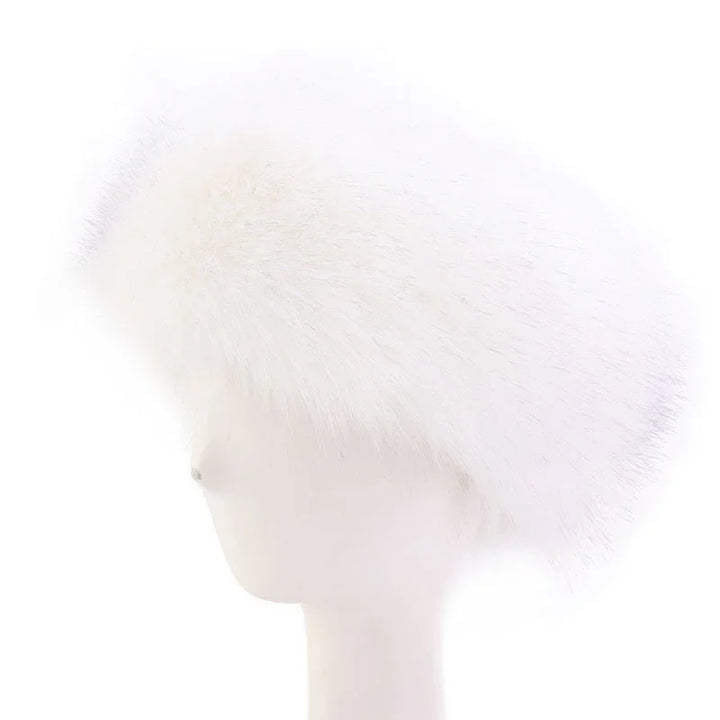 Elegant white mink fur hat displayed on white mannequin head