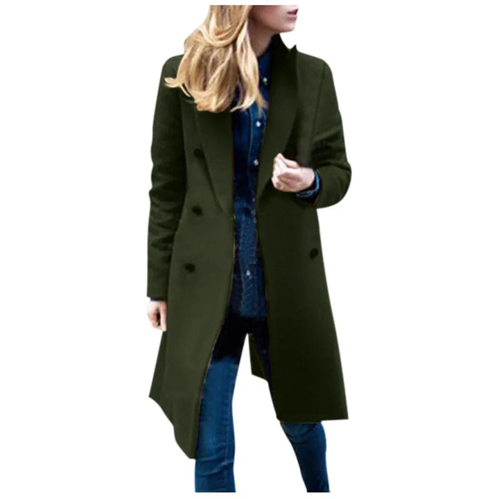 Woman wearing dark green long wool coat over blue denim outfit on white background