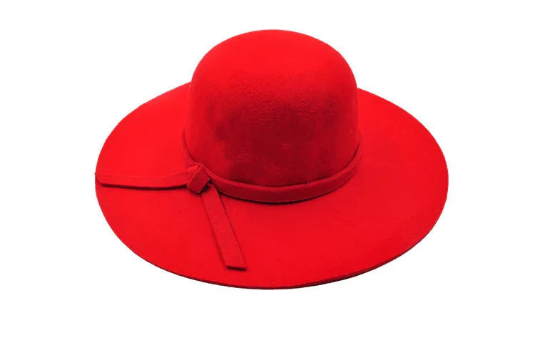 Bright red wide-brimmed felt hat with decorative bow detail on white background