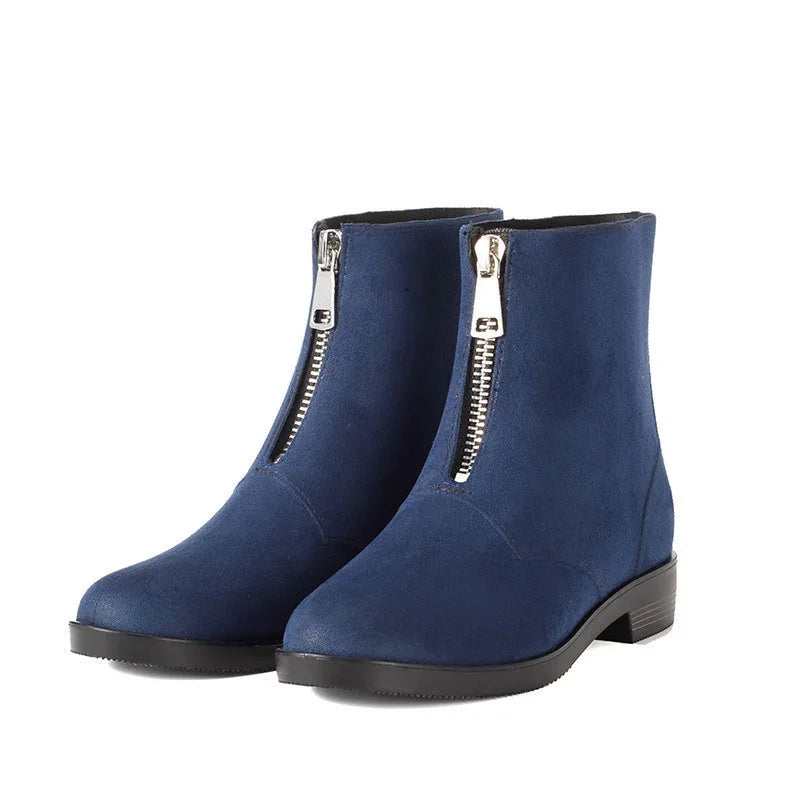 Pair of navy blue suede ankle boots with front silver zippers and low black heels