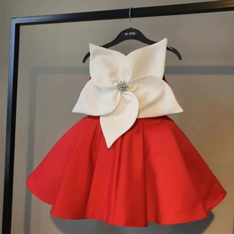 Red sleeveless dress with large white flower applique and rhinestone center on black hanger