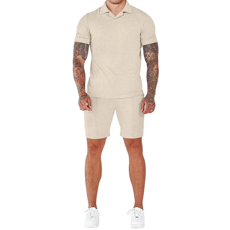 Man wearing beige waffle knit short sleeve polo and matching shorts with white sneakers