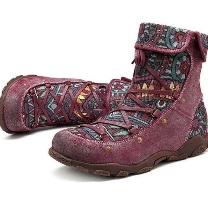 Purple high-top boots with multicolor tribal patterns and crisscross laces on a white background