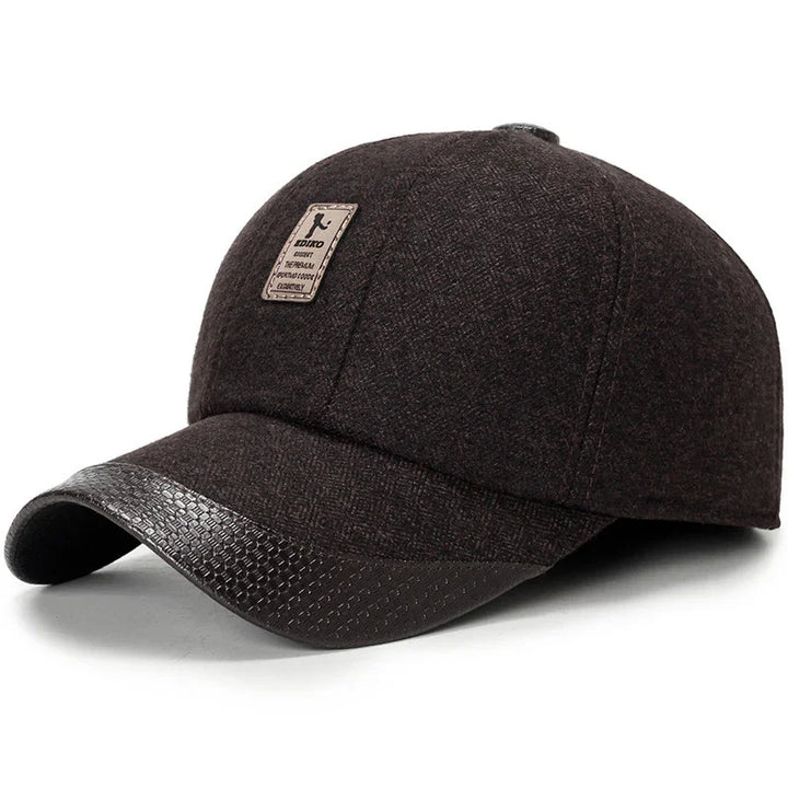 Dark brown wool baseball cap with leather-textured curved brim and front patch logo