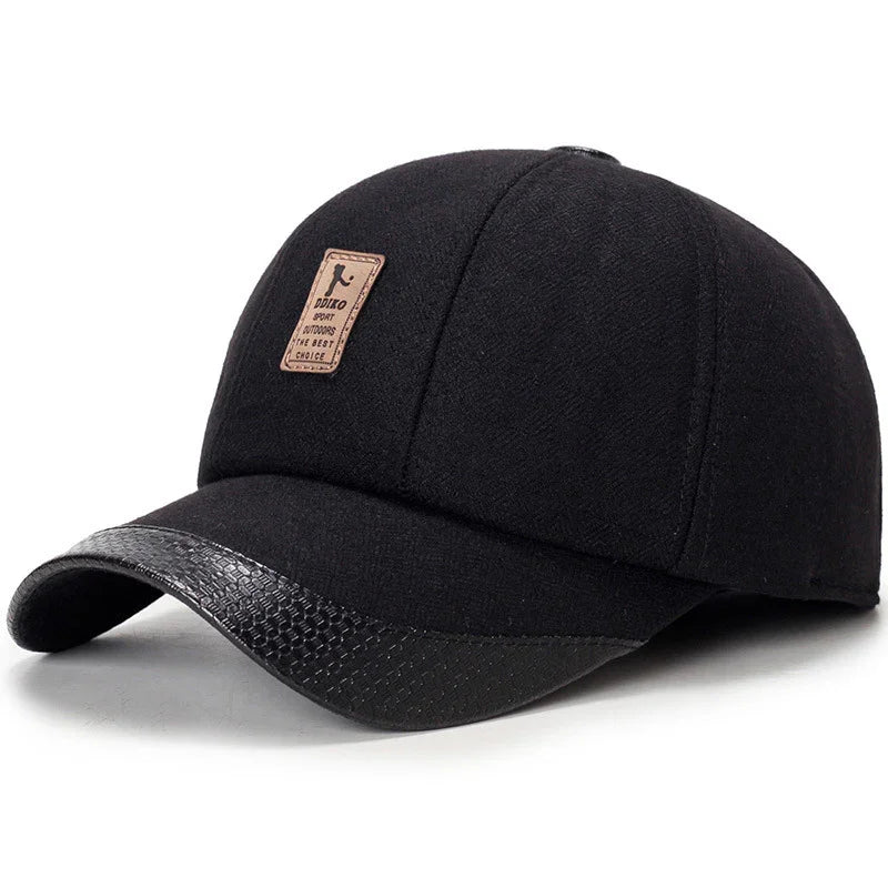 Black baseball cap with leather-textured curved brim and brown patch logo on front