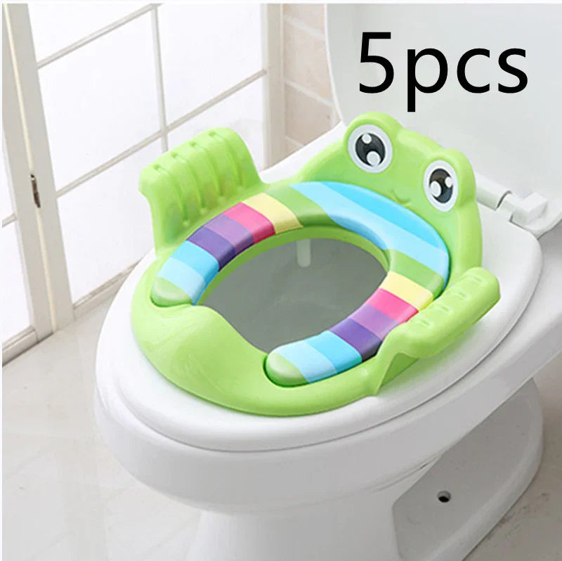 green frog-shaped padded potty training toddler toilet seat on white toilet bowl