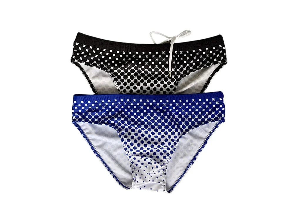 Two men's swim briefs with gradient polka dot patterns, one black and white, one blue and white