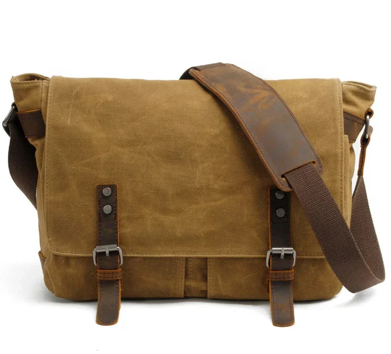 Brown canvas messenger bag with leather straps and adjustable shoulder strap