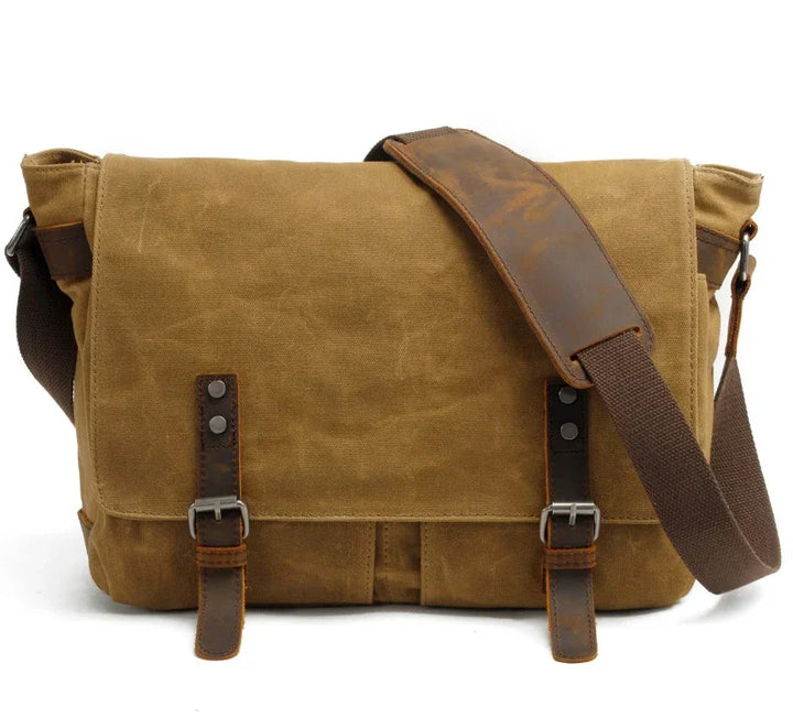 Brown canvas messenger bag with leather straps and adjustable shoulder strap