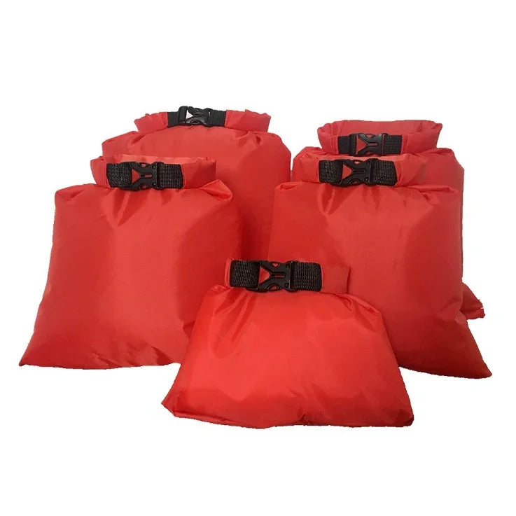 Set of six red waterproof dry bags with black buckles on white background
