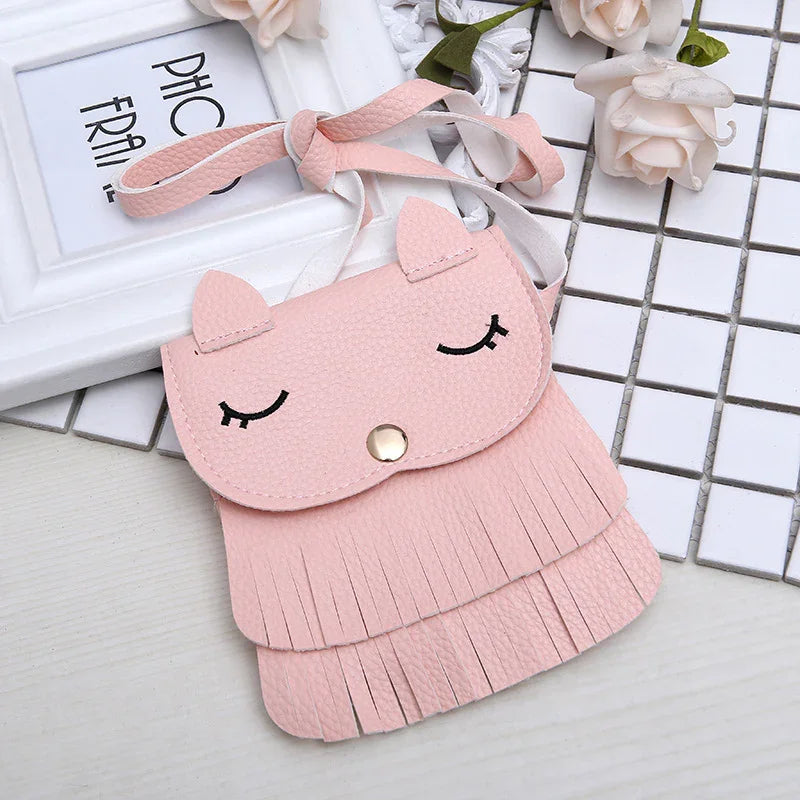 Pink faux leather cute cat face crossbody bag with fringe details and shoulder strap