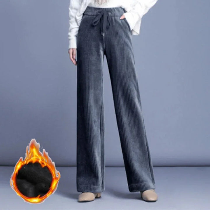 Woman wearing dark gray corduroy wide-leg pants with drawstring waist on gray background