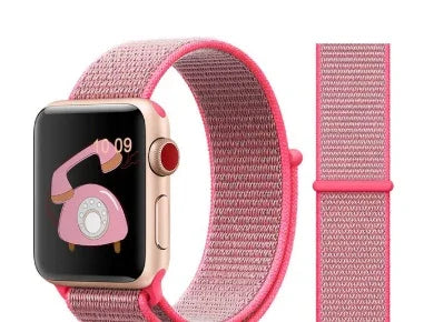 Pink woven nylon Apple Watch band with adjustable loop next to Apple Watch displaying vintage pink rotary phone