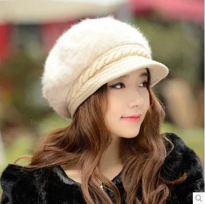 Woman with long wavy hair wearing a cream-colored fuzzy beret and black fur coat outdoors