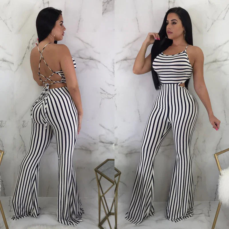Woman wearing black and white vertical striped jumpsuit with crisscross back detailing against marble wall