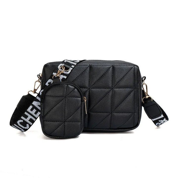 Black quilted crossbody bag with detachable smaller pouch and wide black strap with white lettering