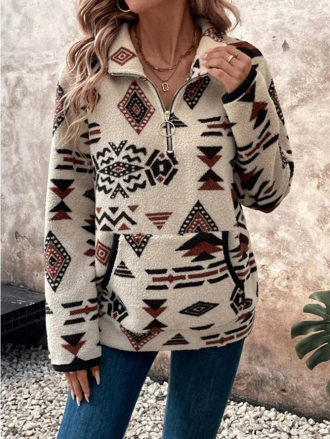 Woman wearing cream fleece pullover with tribal geometric patterns and front pocket