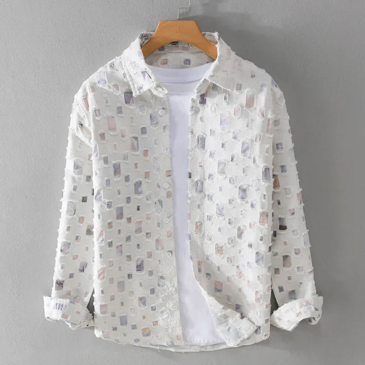 White sheer long sleeve shirt with square cutout pattern layered over plain white t-shirt on wooden hanger