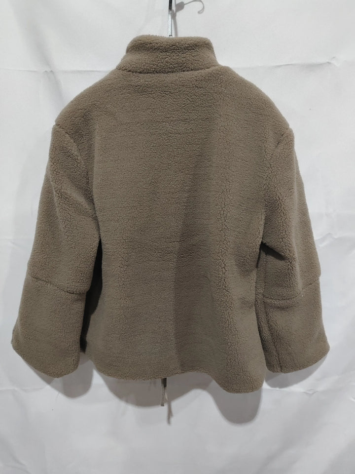 Back view of brown fleece jacket hanging on hanger against white background