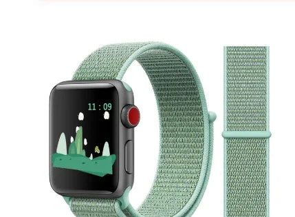 Smartwatch with green woven nylon strap and digital clock display showing 11:09