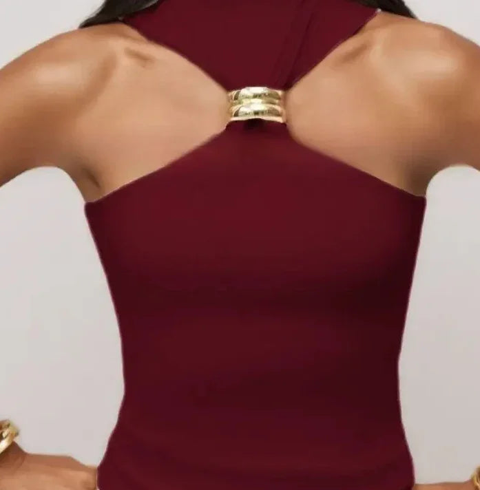 Close-up of woman wearing sleeveless maroon dress with gold ring detail on back