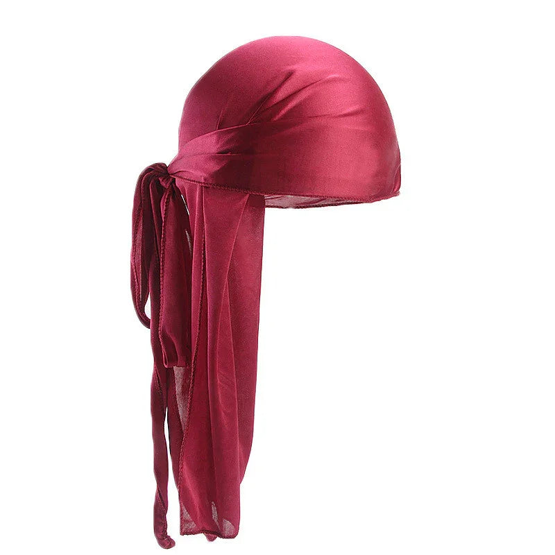 Red satin durag with long, flowing tails tied in a knot, isolated on white background