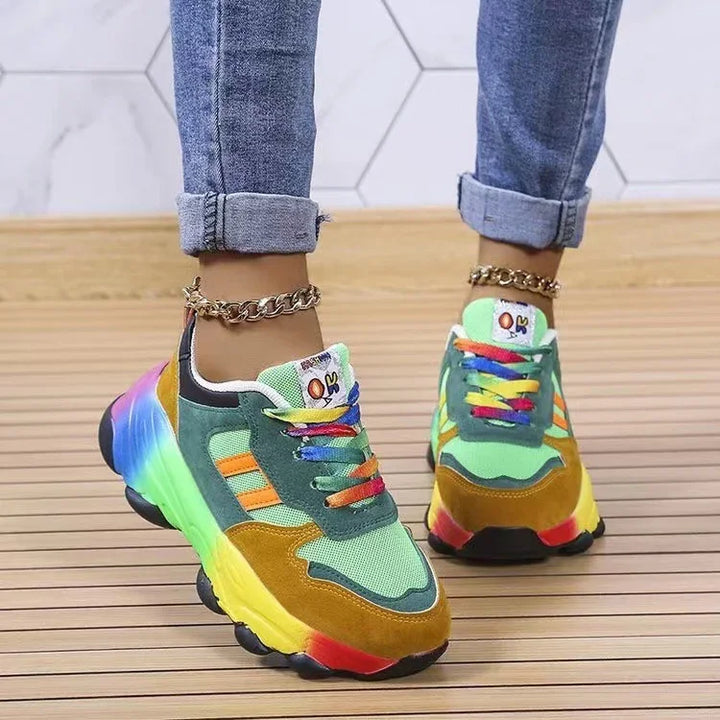 Colorful platform sneakers with rainbow laces and chunky soles worn with rolled-up jeans