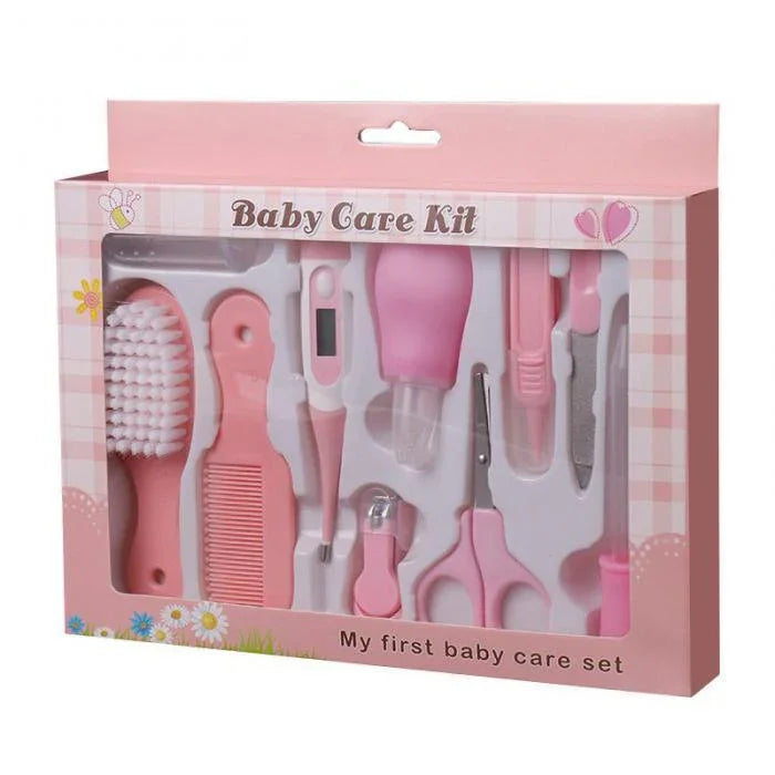 Pink baby care kit with brush, comb, thermometer, nail clipper, scissors, and other grooming tools
