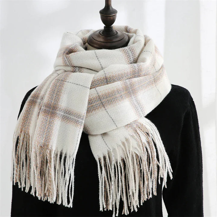 Soft white plaid scarf with beige and gray stripes and fringed ends on black mannequin