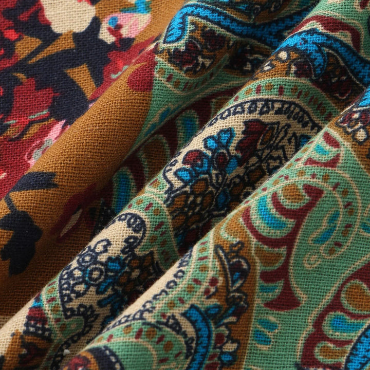 Close-up of colorful paisley patterned fabric with blue, red, green, and mustard tones