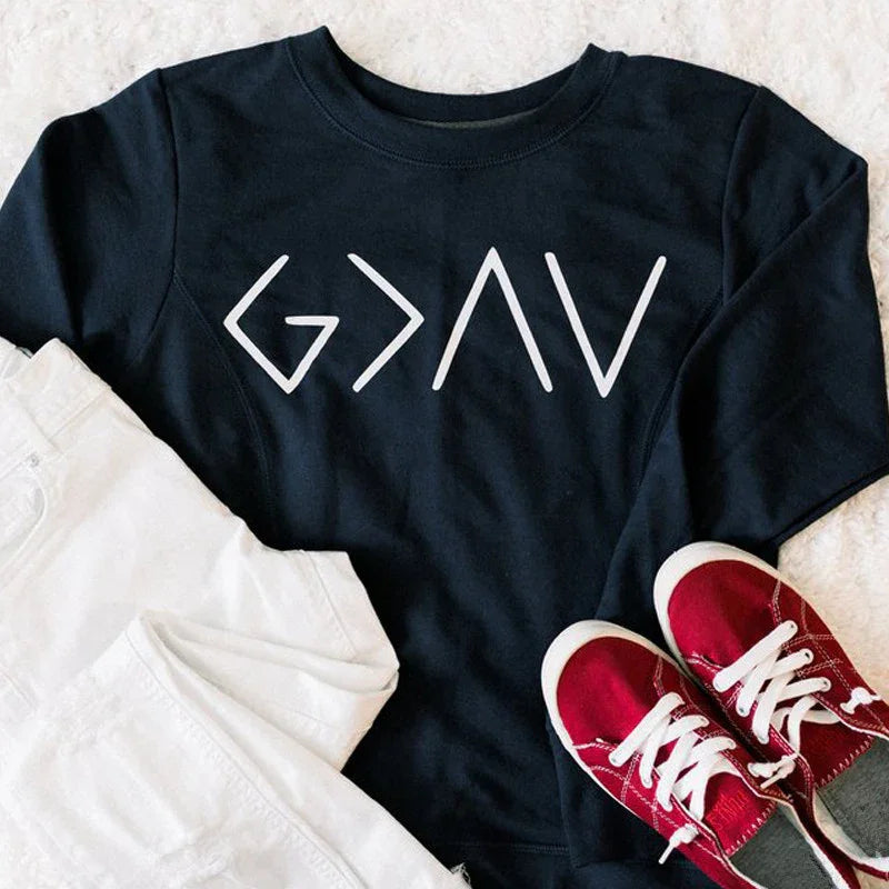 Black sweatshirt with white Go Navy logo, white pants, and red sneakers on soft beige background