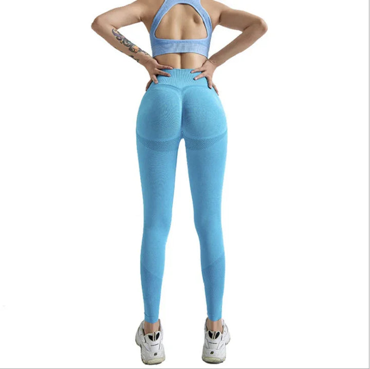 Woman wearing light blue seamless high-waisted leggings and matching sports bra with cutout back, white sneakers