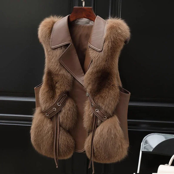 luxury brown fur and leather sleeveless vest hanging on wooden hanger against black background