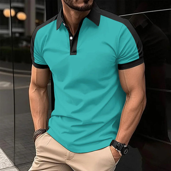 Muscular man wearing turquoise and black short-sleeve polo shirt with beige pants outdoors