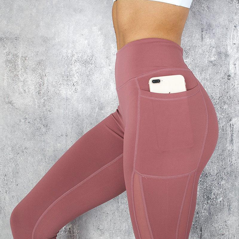 High waisted mauve leggings with side pocket holding smartphone, activewear fashion