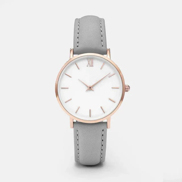 Minimalist wristwatch with rose gold case, white dial, and grey leather strap