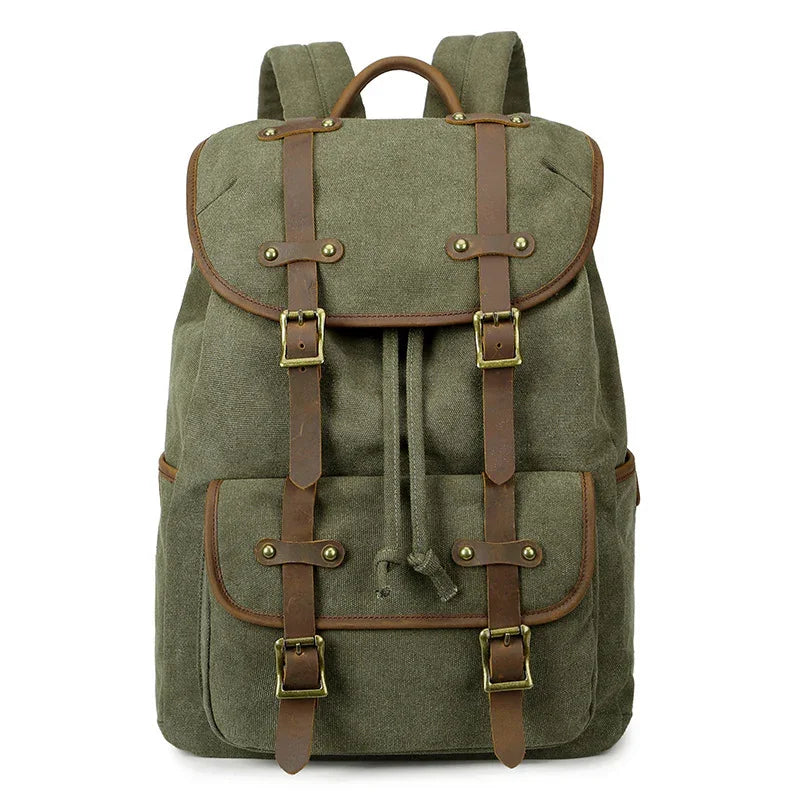 Green canvas backpack with brown leather straps, brass buckles, front pocket, and drawstring closure