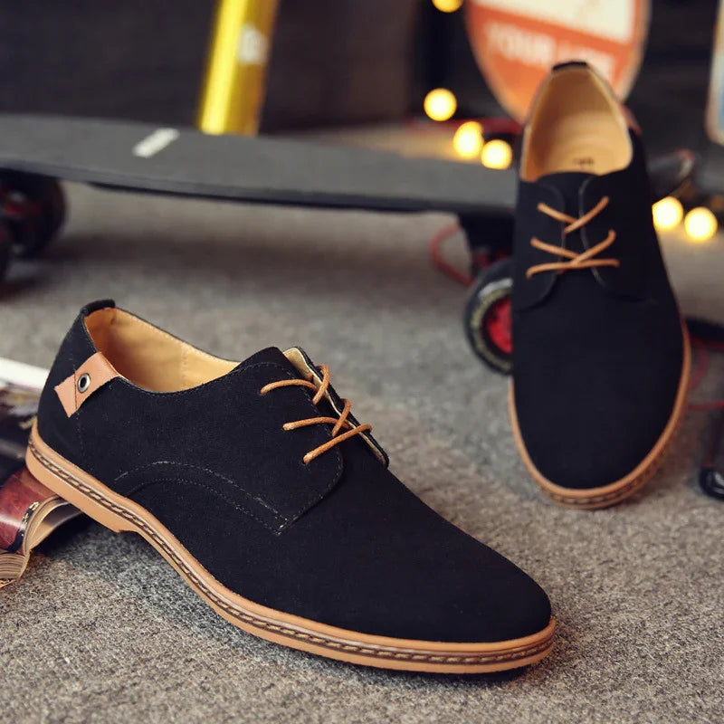 Black casual men's shoes with brown laces and sole on carpeted floor, skateboard in background