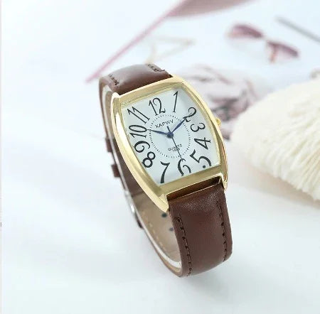 Elegant wristwatch with distorted black numbers gold-tone rectangular case and brown leather strap