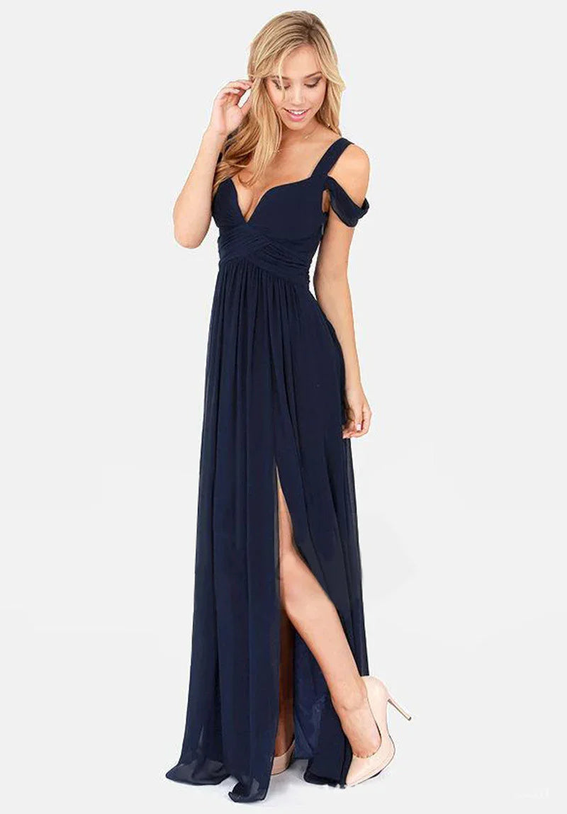 Blonde woman wearing elegant navy blue evening gown with a thigh-high slit and off-shoulder strap