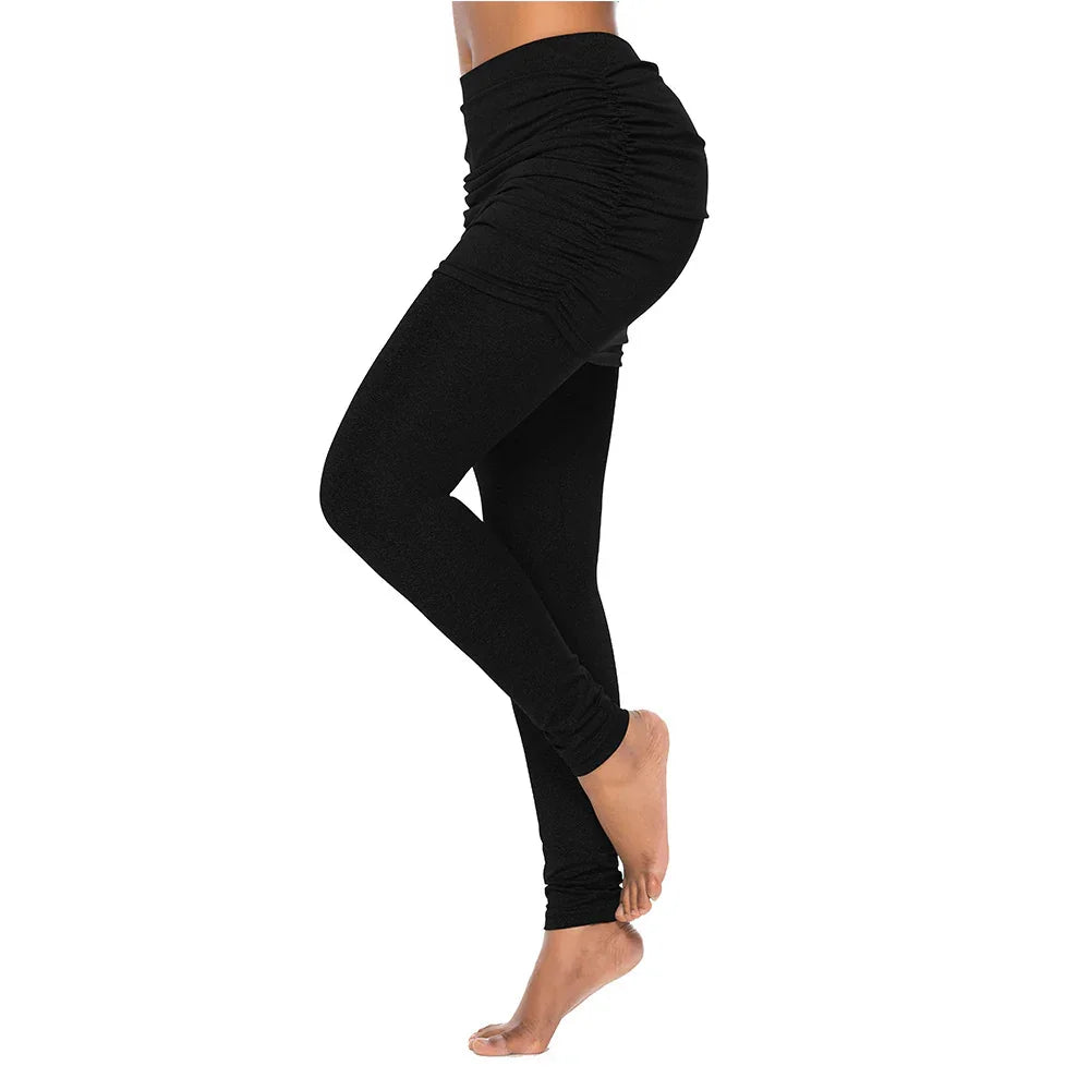 Side view of a person wearing black ruched high-waisted leggings with bare feet on white background