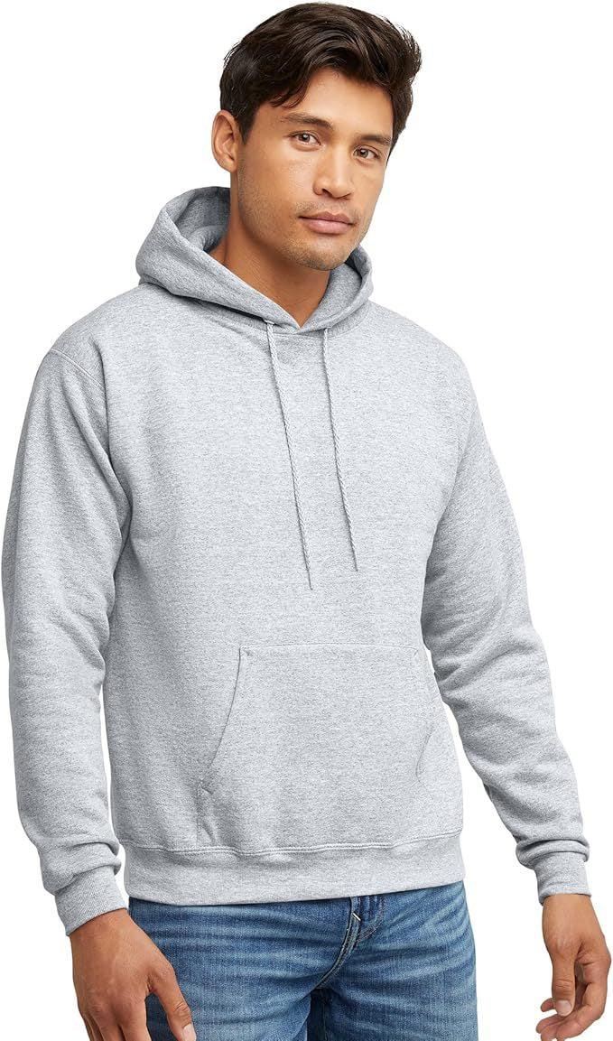 Man wearing light gray pullover hoodie with kangaroo pocket and blue jeans on white background