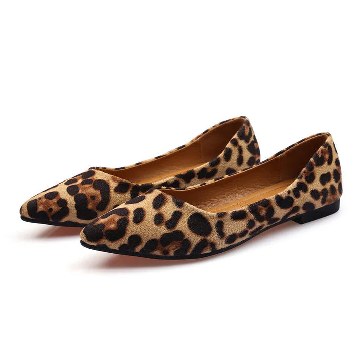 Pair of women's pointed-toe leopard print flat shoes with tan and black spots