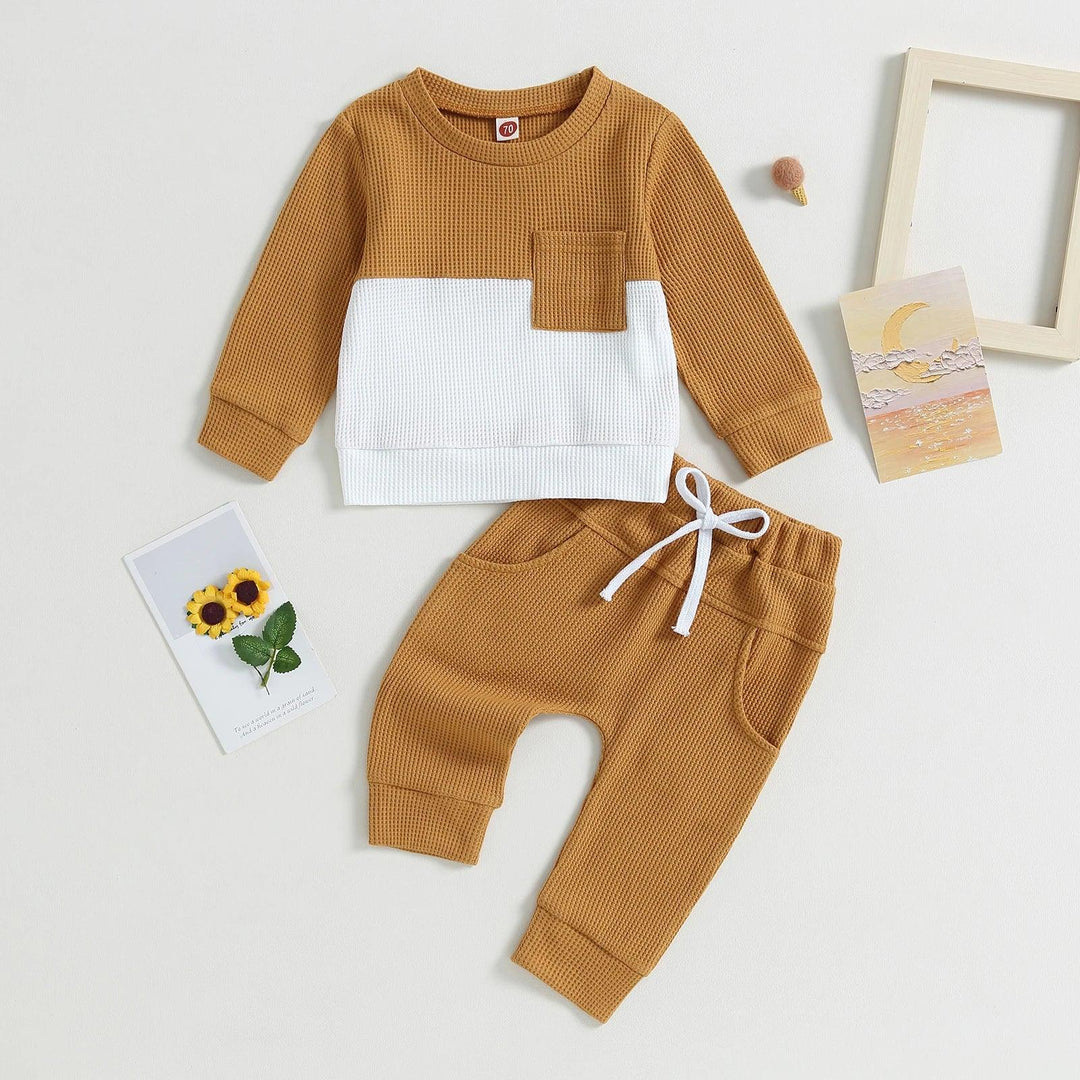 Toddler two-piece waffle knit outfit in mustard and white with pocket and drawstring pants