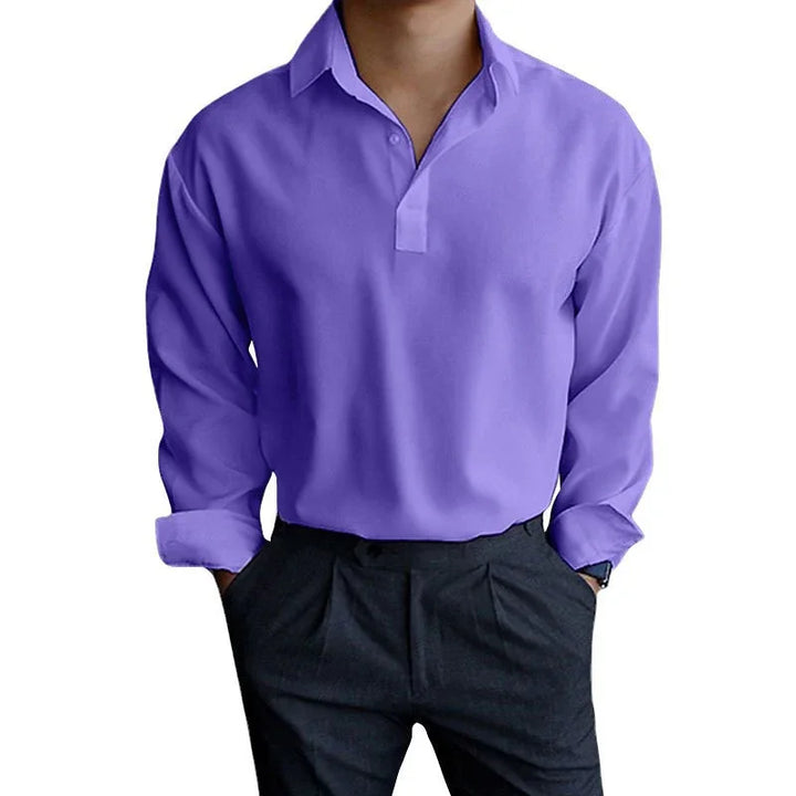Man wearing a long sleeve lavender purple casual shirt with black pants, hands in pockets