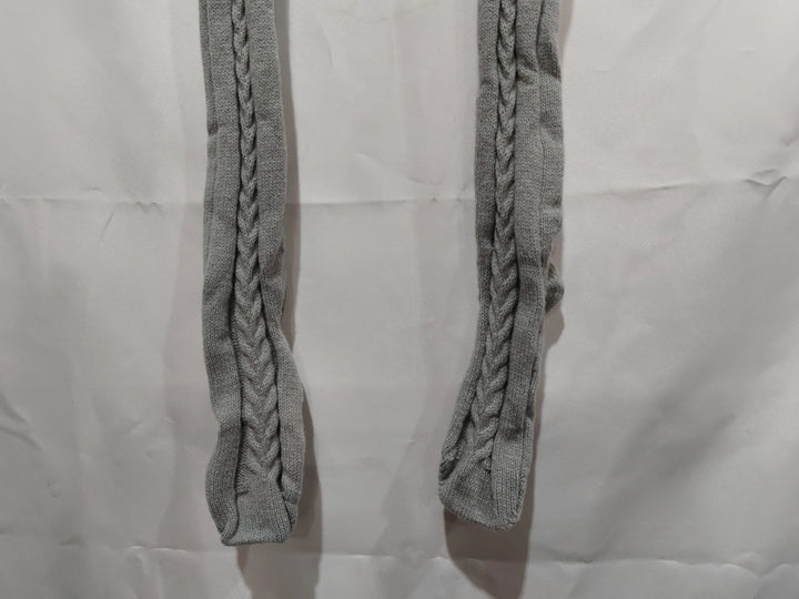Pair of grey knit cable pattern socks laid flat on a white crumpled background