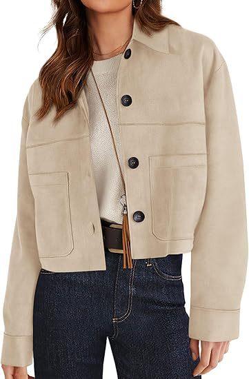 Beige cropped jacket with black buttons over cream knit top, paired with dark blue high-waisted jeans