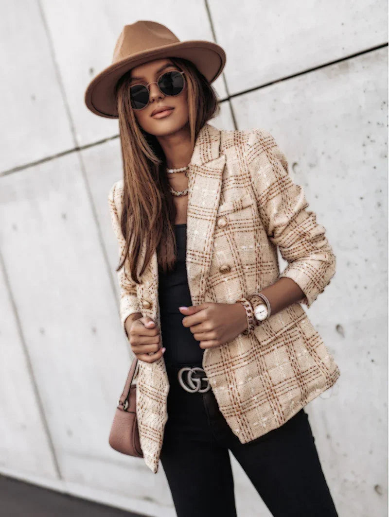 Stylish woman wearing brown hat, sunglasses, beige plaid blazer, black top, and black pants with Gucci belt